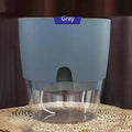 Self-watering plant pot with clear water reservoir