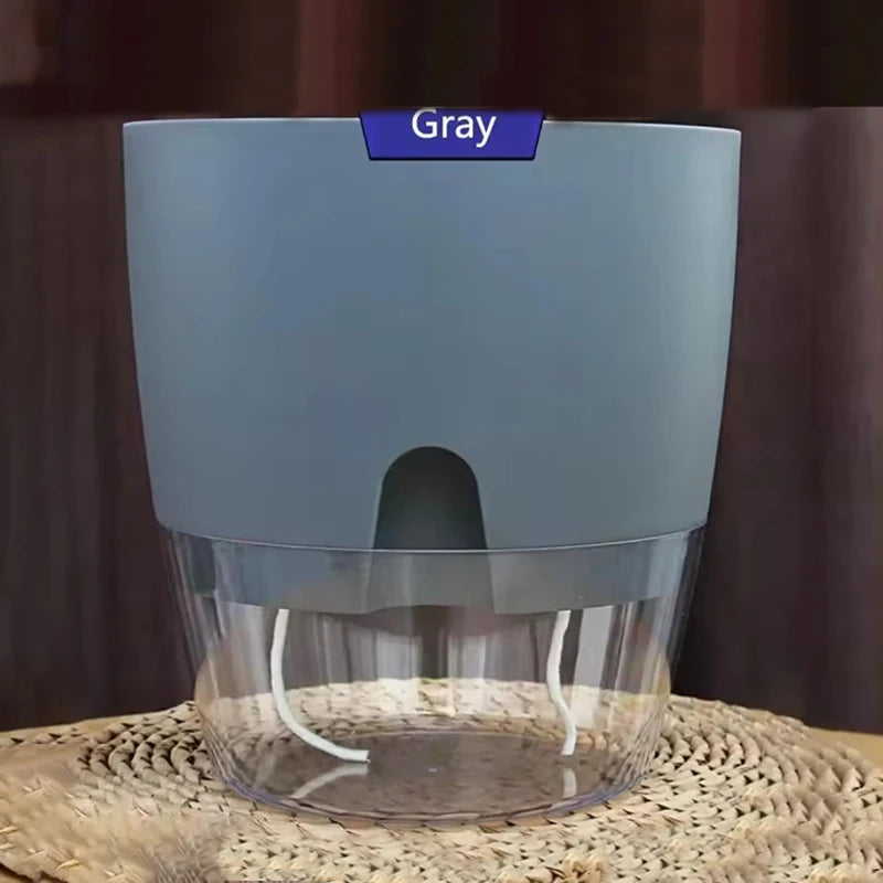 Self-watering plant pot with clear water reservoir