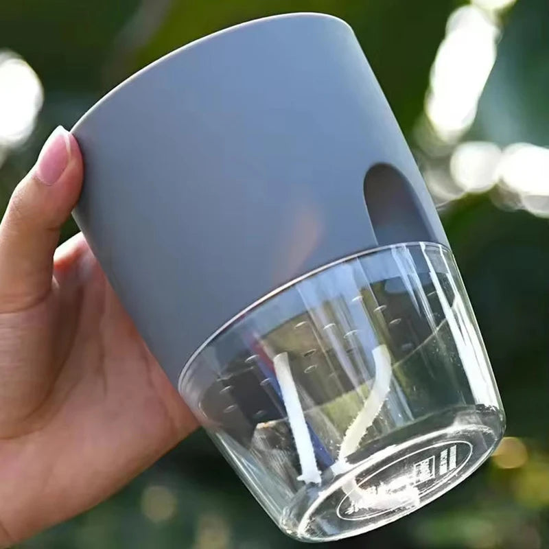 Self-watering plant pot with clear water reservoir