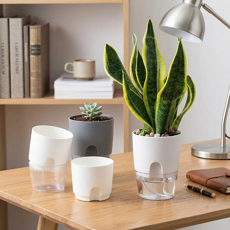 Self-watering plant pot with clear water reservoir